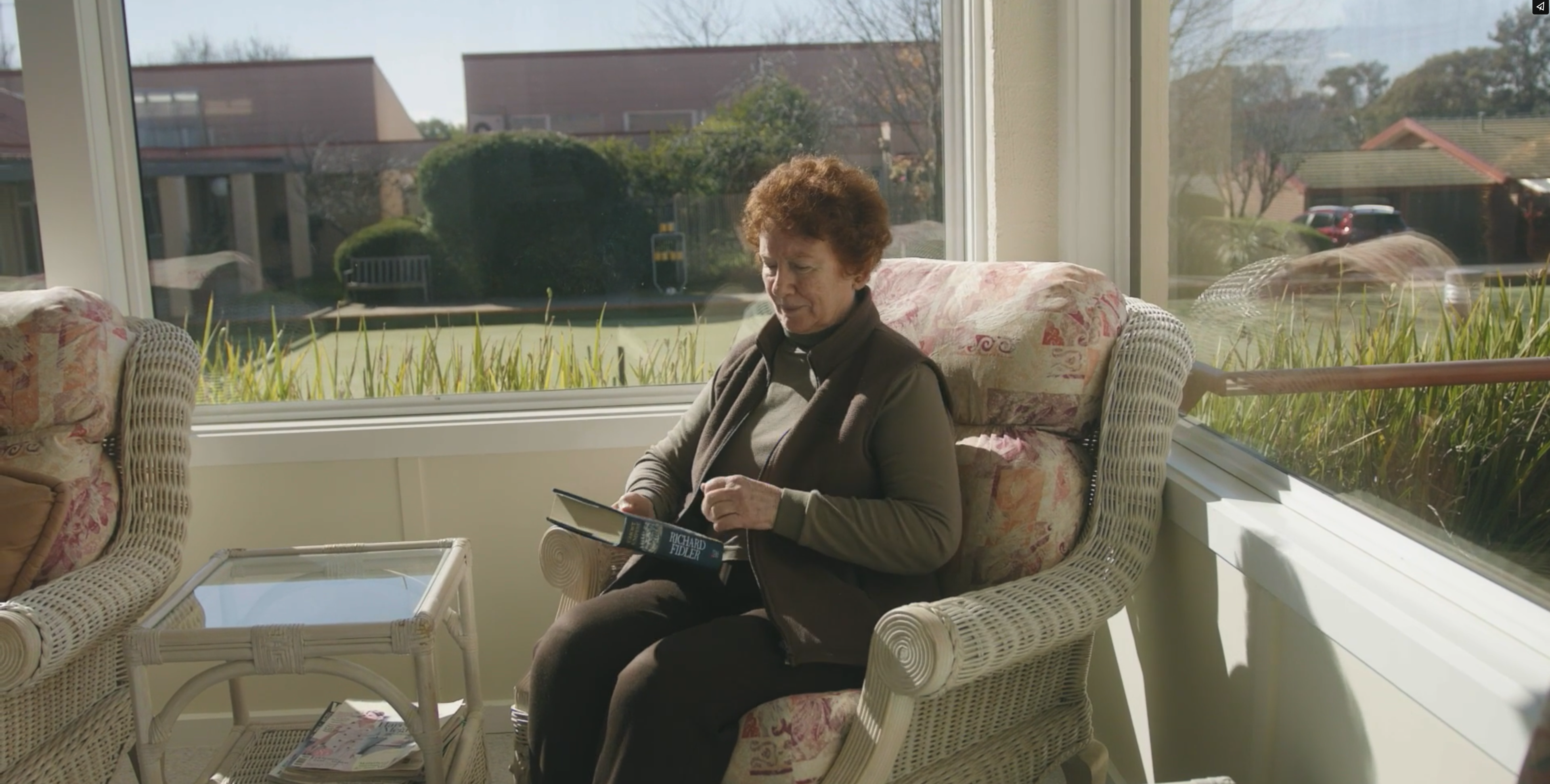 Woman reading book by window